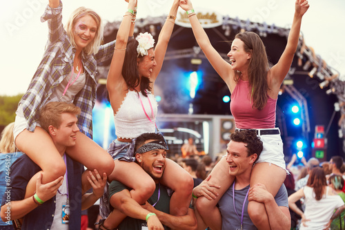 Friends having fun in the crowd at a music festival photo