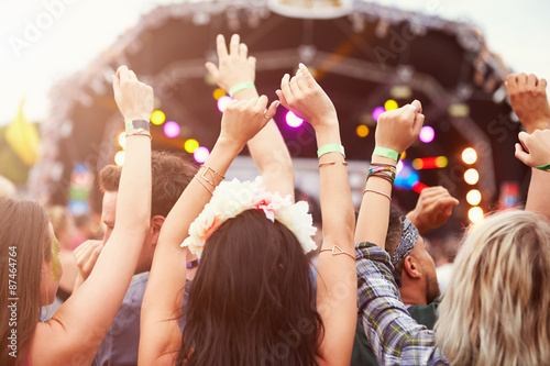 Audience with hands in the air at a music festival