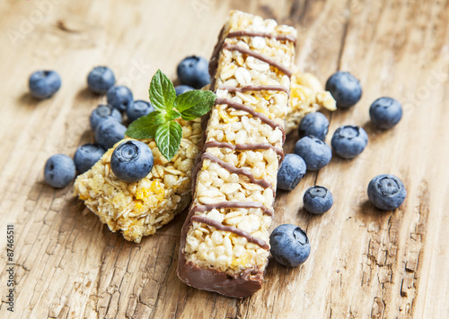 Chocolate Muesli Bar with Blueberries on Wooden Background