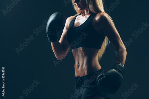 beautiful woman with the red boxing gloves,black background