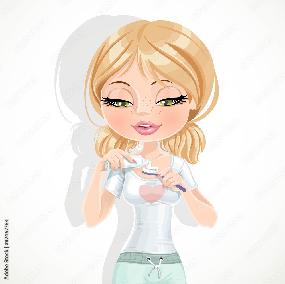 Cute blond girl extrudes the toothpaste from a tube on toothbrus Cute blond girl extrudes the toothpaste from a tube on toothbrus