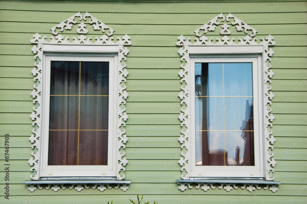Fototapeta premium windows of the wooden houses are decorated with wood carvings