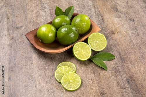 Fresh citrus lime with mint close up on wooden background