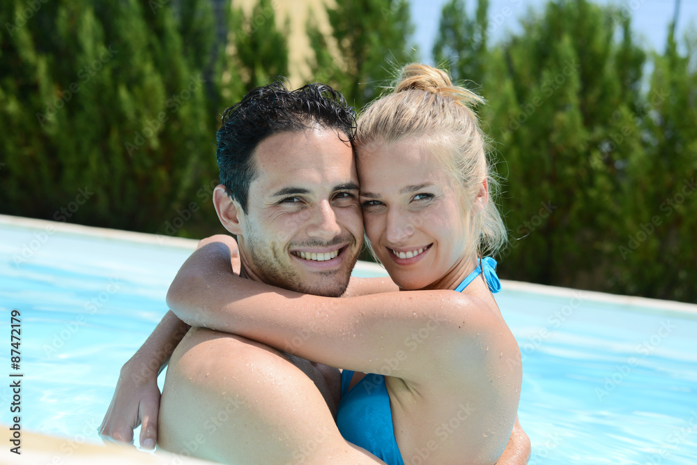 Fototapeta premium beautiful young couple in love playing together in a swimming pool