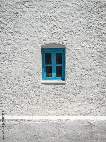 Blue window on a white wall