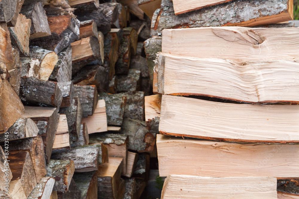 Dry logs stacked in a pile in the garden Dry logs stacked in a pile in the garden