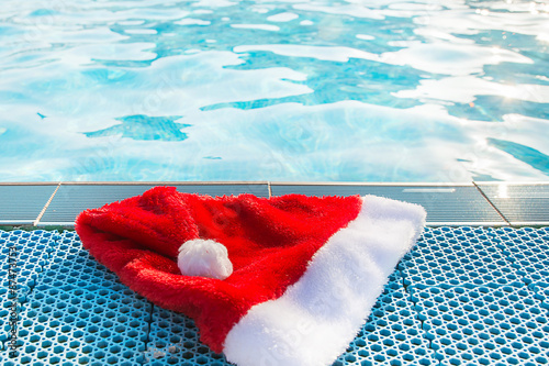Christmas hat by the swimmingpool on a sunny day