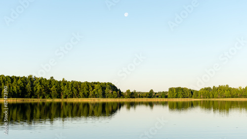 Fototapeta Naklejka Na Ścianę i Meble -  symmetric reflections on calm lake