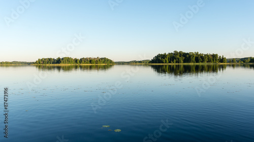 Fototapeta Naklejka Na Ścianę i Meble -  symmetric reflections on calm lake