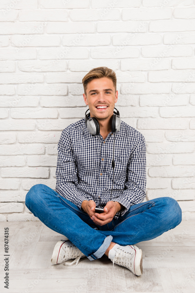 man with headphones sitting on the floor man with headphones sitting on the floor