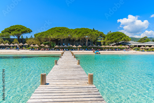 Wooden jetty and turquoise sea water on beautiful Santa Giulia beach, Corsica island, France © pkazmierczak