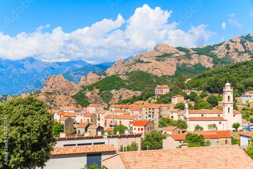 View of Piana village with church tower in mountain landscape of western Corsica, France