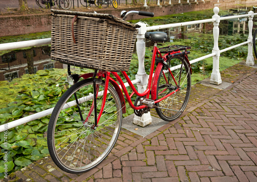 Red Bicycle Beside a Canal in Netherlands