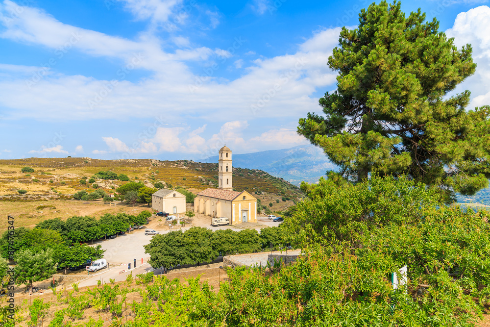 Church in small village of Sant Antonino in mountain landscape of Corsica island, France