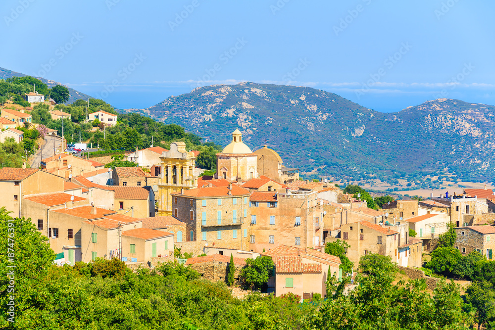 View of Cateri village with stone houses built in traditional Corsican style on top of a hill, France