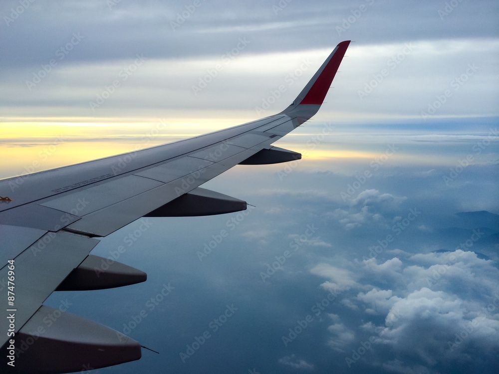 Wind of the plane with cloudy sky on background at sunset Wind of the plane with cloudy sky on background at sunset