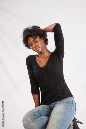 Pretty black woman sitting thoughtfully © Allen Penton