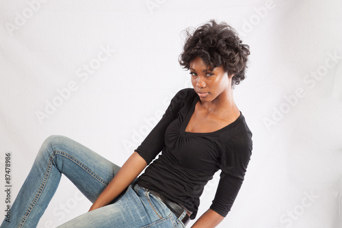 Pretty black woman sitting thoughtfully photo