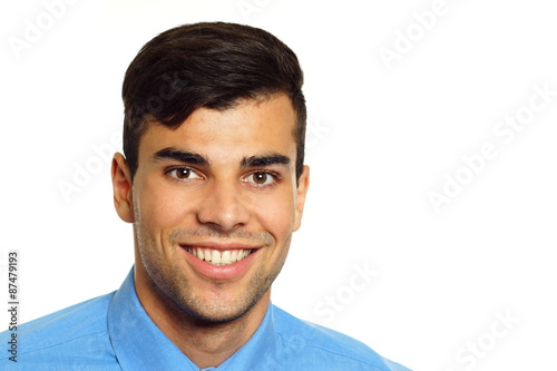 Portrait of young smiling businessman in blue shirt, right you can write some text