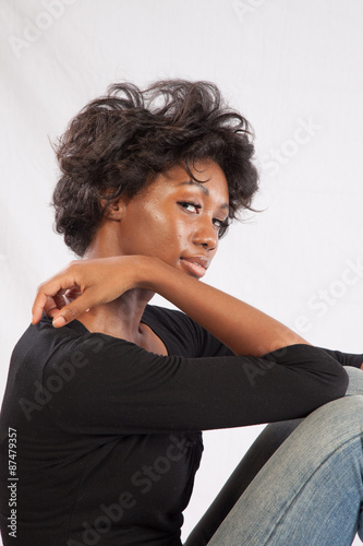 Pretty black woman sitting thoughtfully