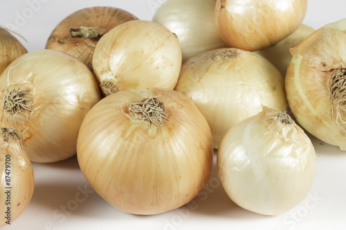 Several onions on white background