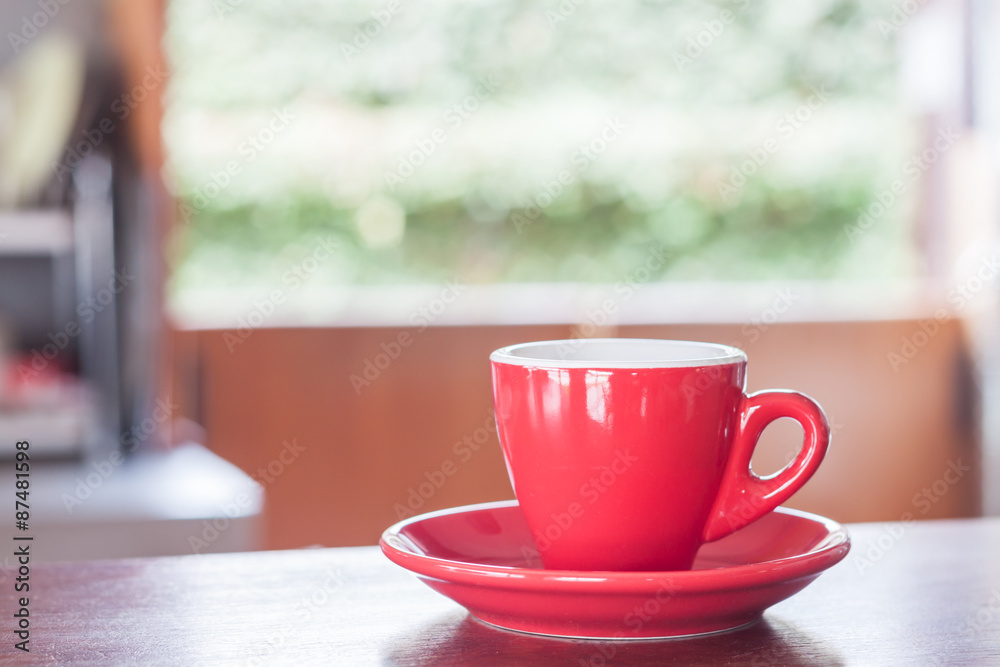 Red coffee cup on wooden table