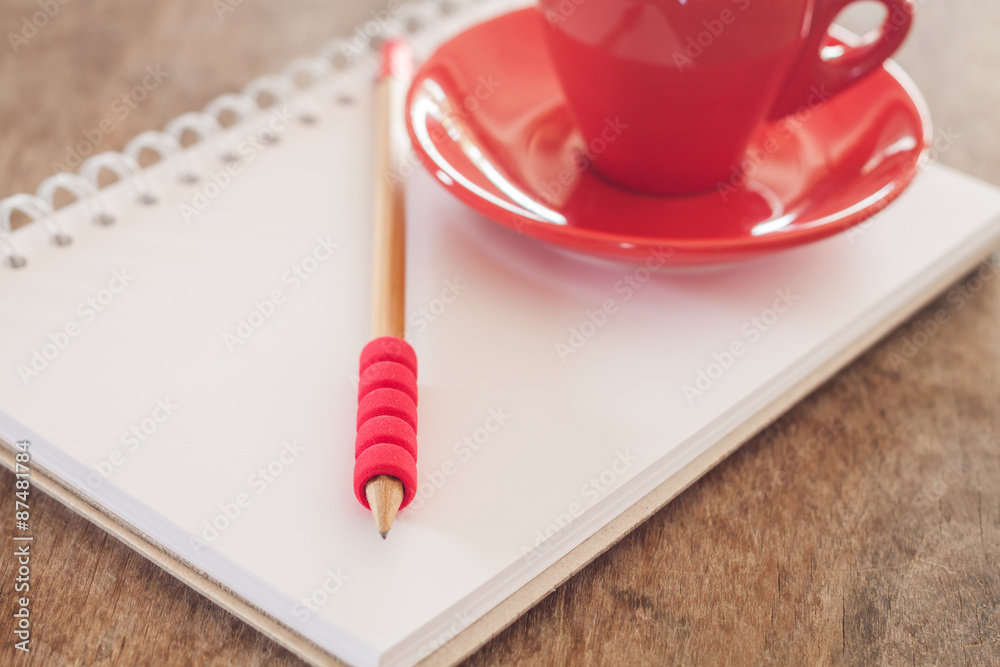 Red mug with open notebook Red mug with open notebook