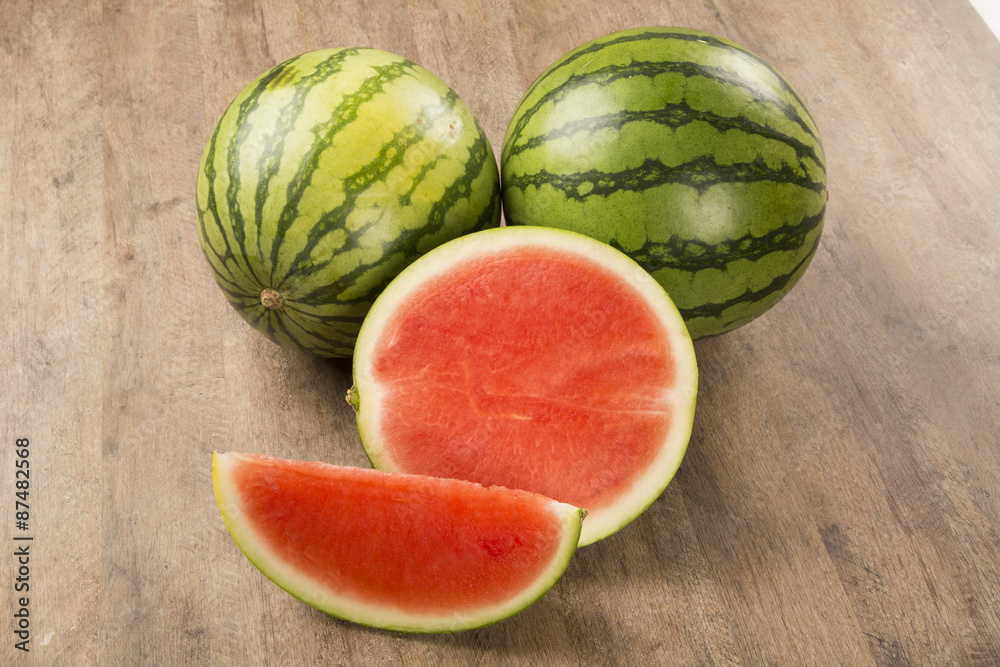 slices of watermelon on wooden table slices of watermelon on wooden table