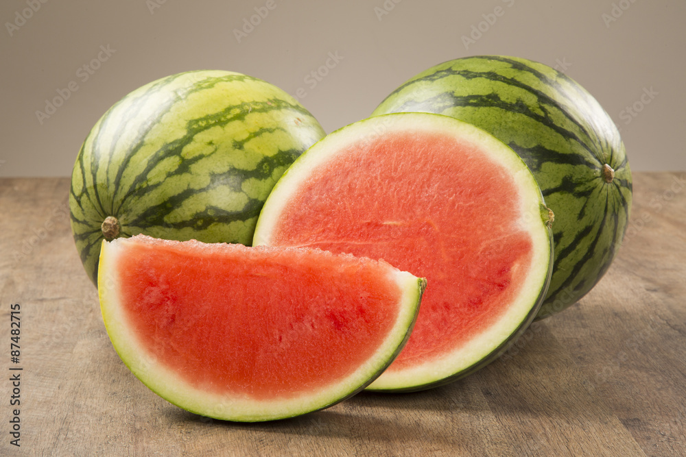 slices of watermelon on wooden table slices of watermelon on wooden table