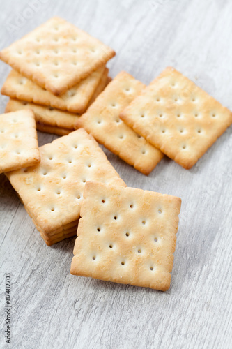 Stack of square crackers on wooden table