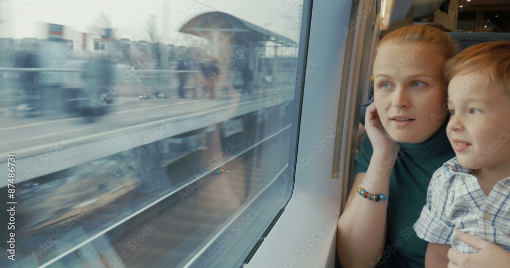 Mother and son traveling across the city by train