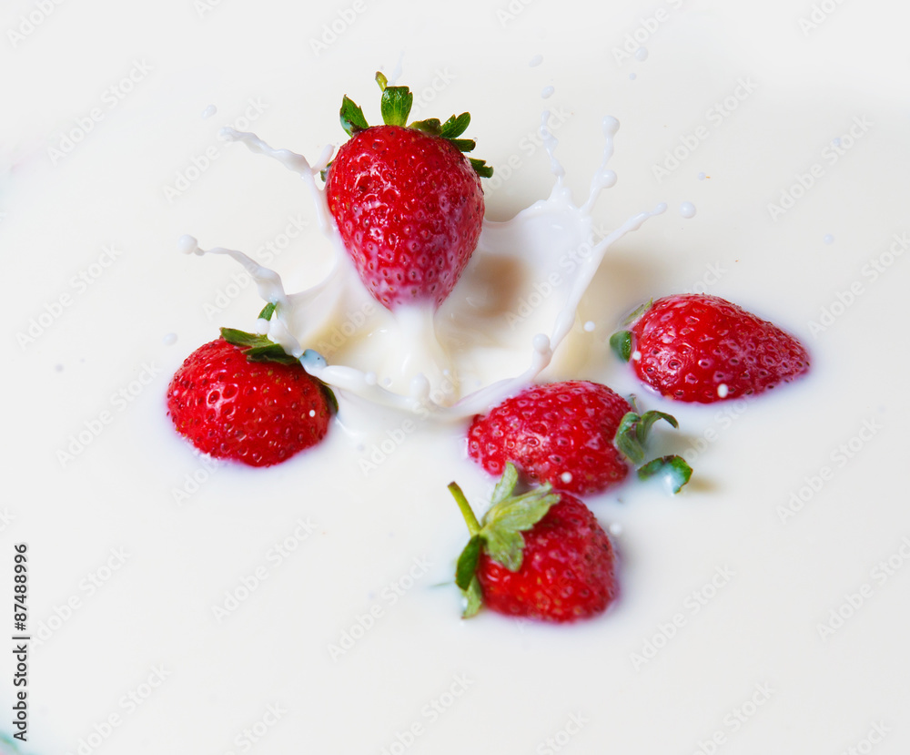 Splashes of milk and strawberries Splashes of milk and strawberries