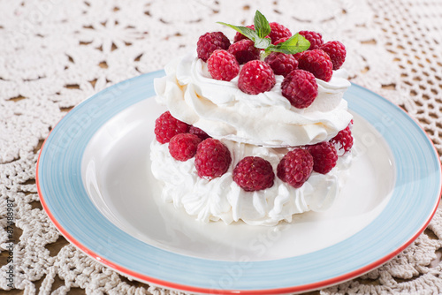 Sweet meringue delicious dessert with raspberry and cream