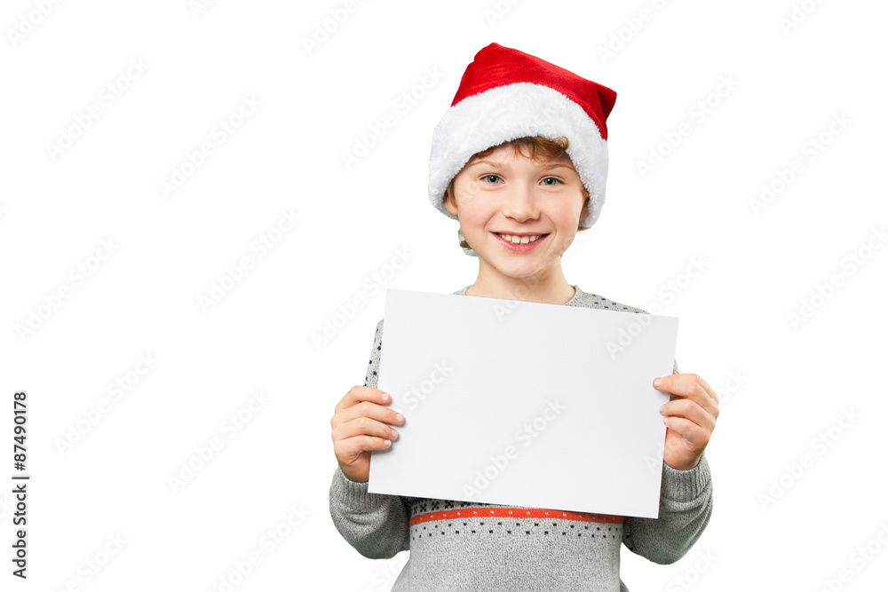 Portrait of a boy in christmas hat holding white blank. Isolated Portrait of a boy in christmas hat holding white blank. Isolated