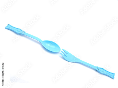 Plastic baby spoon on a white background