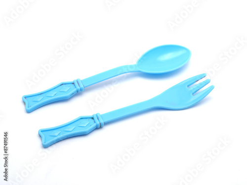 Plastic baby spoon on a white background