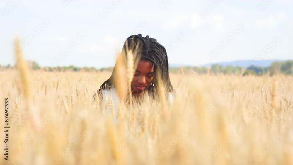 Beautiful Black Woman Sitting in a Wheat Field Beautiful Black Woman Sitting in a Wheat Field