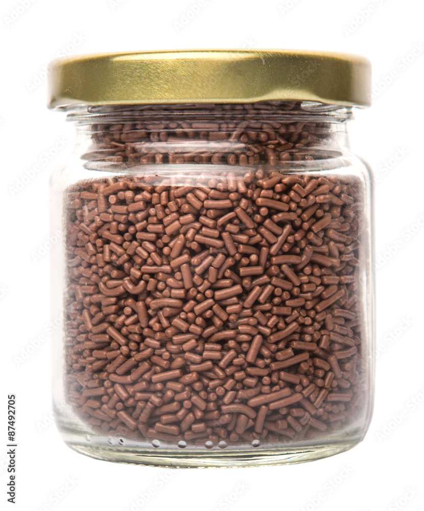 Chocolate sprinkle confetti in a mason jar over white background Chocolate sprinkle confetti in a mason jar over white background