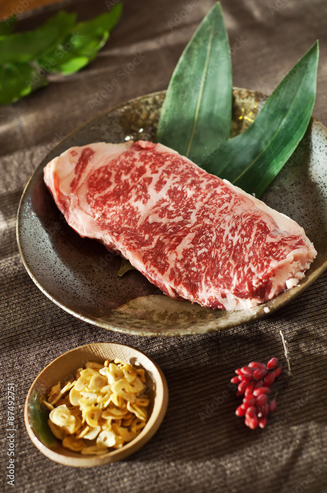 marbled veal Kobe with garlic chips. Raw fresh meat Black Angus Steak. marbled veal Kobe with garlic chips. Raw fresh meat Black Angus Steak.