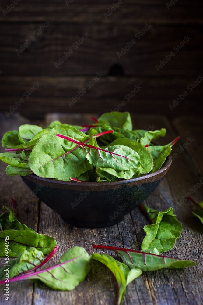 Fresh chard leaves on rustic background Fresh chard leaves on rustic background
