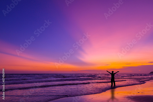 Silhouette of a man on the beach at twilight