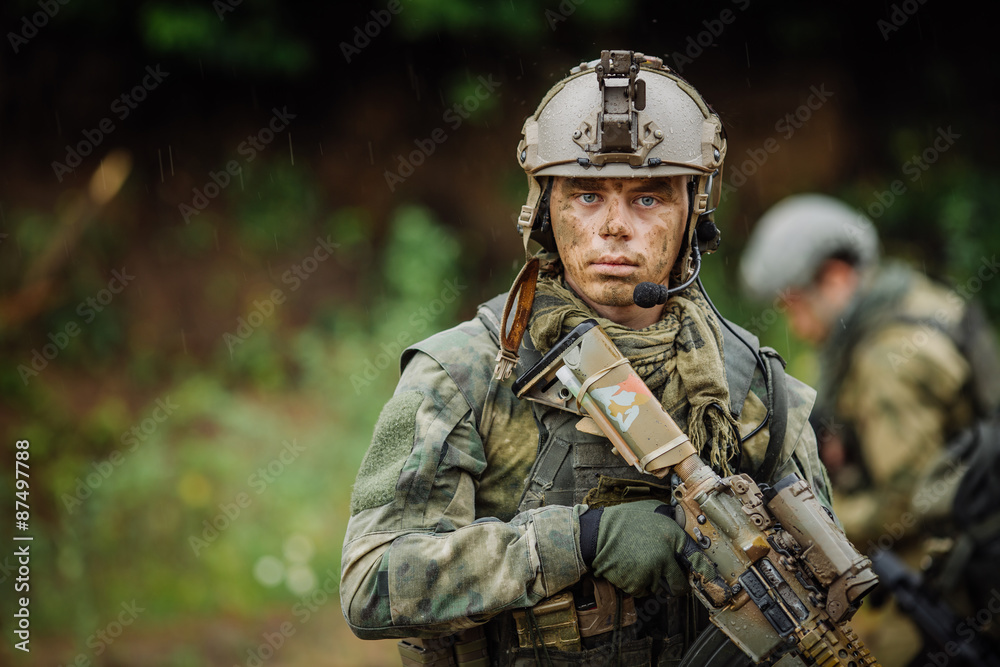 Portrait of a ranger in the battlefield with a gun Portrait of a ranger in the battlefield with a gun