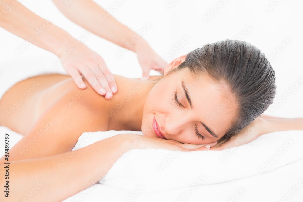 Attractive woman receiving back massage at spa center Attractive woman receiving back massage at spa center