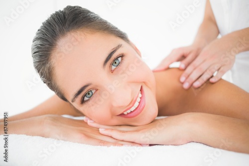 Attractive woman receiving back massage at spa center