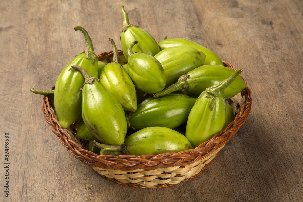 Some green african eggplants over a wooden surface Some green african eggplants over a wooden surface