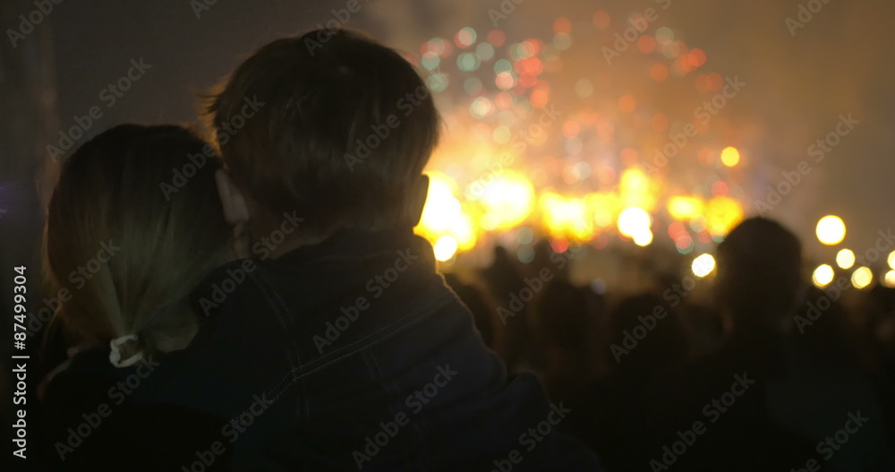Mother and little son watching fireworks