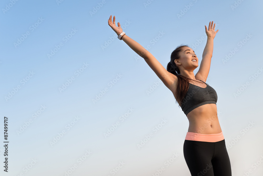 Happy asian woman raising arms to the sky. Happy asian woman raising arms to the sky.