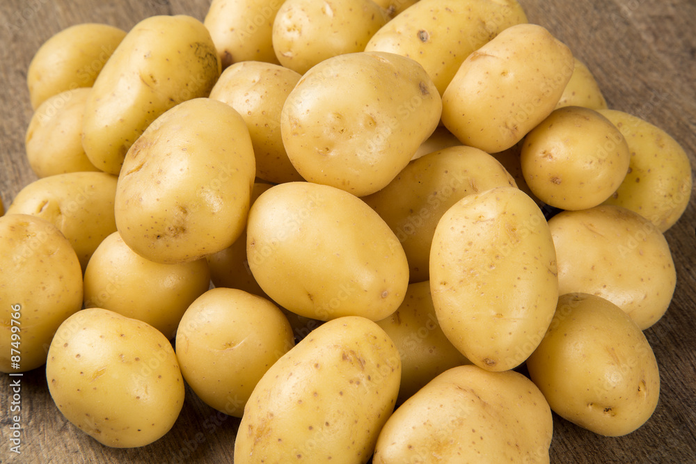 Some potatoes over a wooden surface Some potatoes over a wooden surface