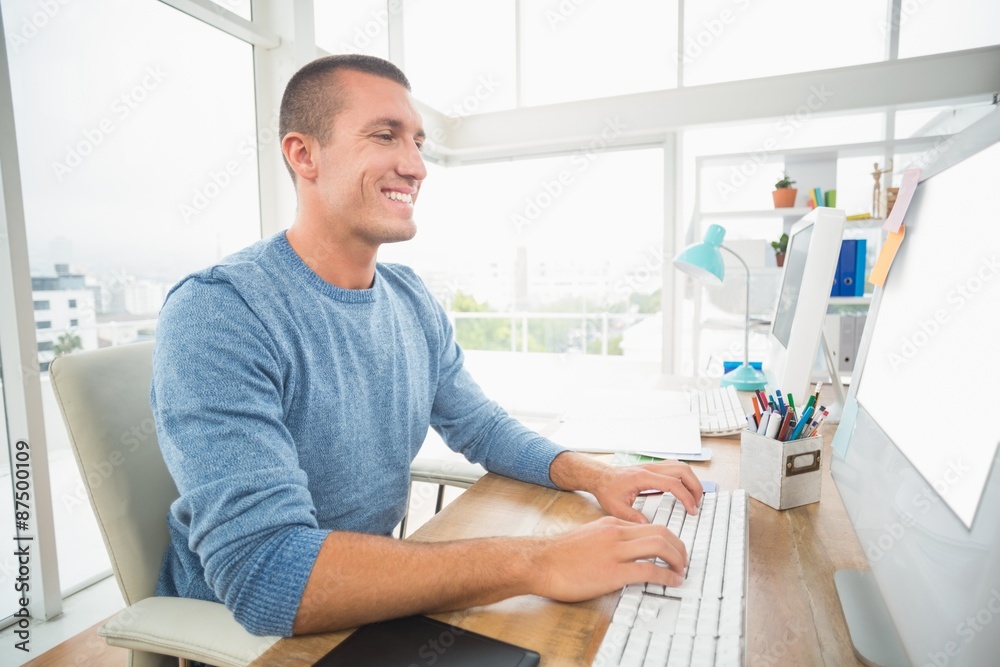 Young creative businessman typing on the computer Young creative businessman typing on the computer