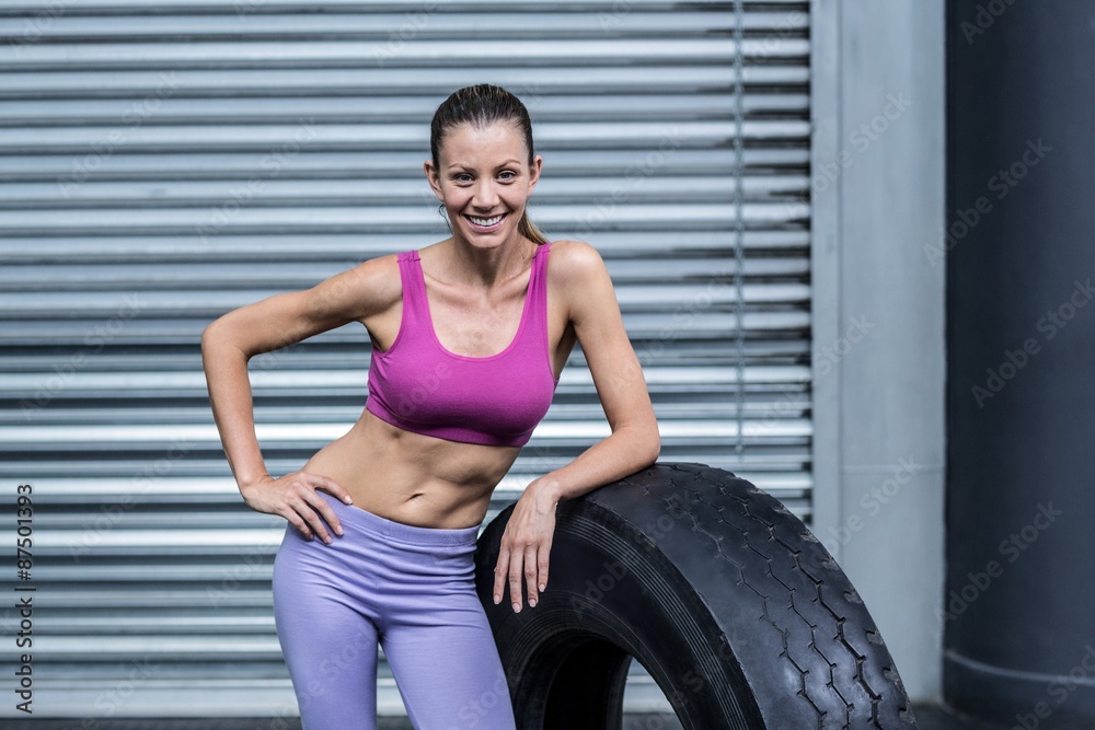 Smiling muscular woman looking at the camera